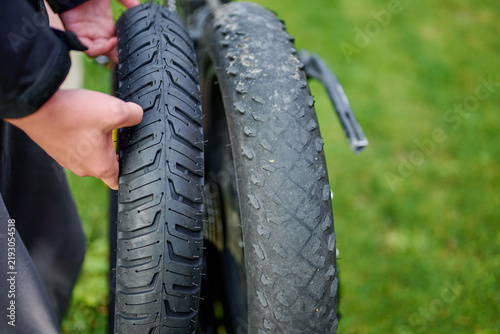 Bicycle mechanic holding new replacement tire for e-bike