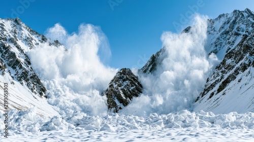 Massive avalanche cascading down snowy mountain peaks into a deep valley under a clear blue sky