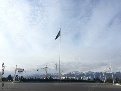 Canvastavla Ashgabat Main Flagpole with Turkmen flag and Kopetdag mountains Turkmenistan