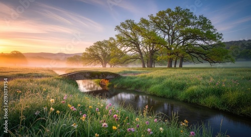 Picturesque countryside landscape with stone bridge at sunrise.