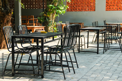 Outdoor cafe seating with black metal table and chairs