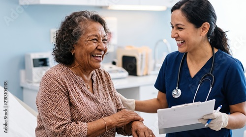 Senior patient visiting the general practitioner. The older woman laughs heartily sharing a joyful moment with her doctor holding a tablet.