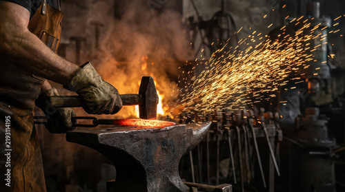 Medieval blacksmith working with glowing hot metal on an anvil in a rustic forge, surrounded by fire, sparks and dark stone walls, illustrating traditional craftsmanship and skilled metalworking
