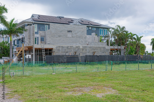 Canvastavla A coastal two-story house raised on concrete pilings and temporary wooden suppor