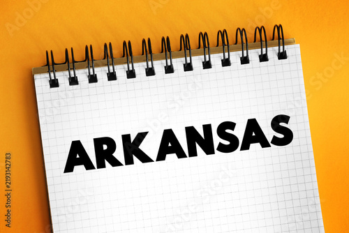 Arkansas is a landlocked state in the South Central region of the Southern United States, text concept on notepad