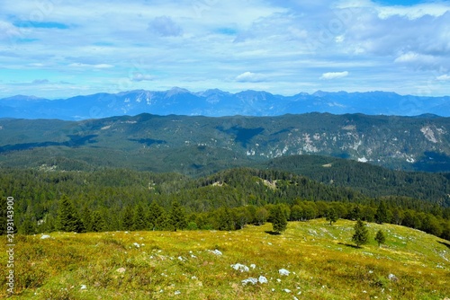 Panoramic view of Gorenjska with forest covered Jelovica plateau and Karavanke mountains in the distance in Slovenia