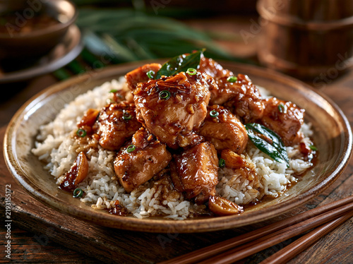 Filipino chicken adobo combines tender chicken with soy sauce, vinegar, garlic and bay leaves, served with rice as a beloved national dish.
