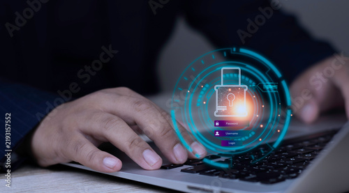 Secure password authentication and data encryption concept with user typing on laptop keyboard displaying glowing lock icon, username, and password login interface on dark background.