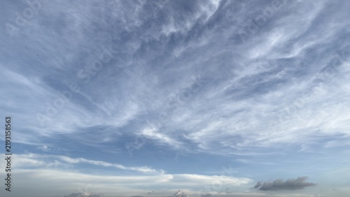 Beautiful blue sky filled with wispy white cirrus clouds gracefully
