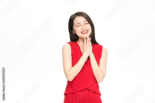 Obraz na płótnie Happy Young Asian Woman in Red Dress Smiling with Hands Clasped