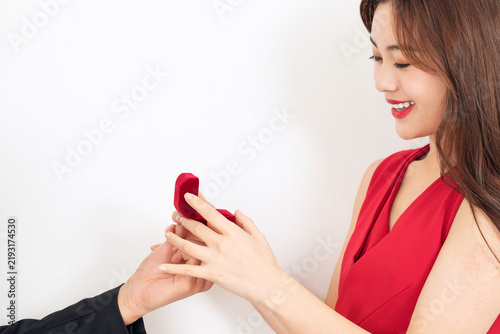 Obraz na płótnie Happy Asian Woman Receiving Engagement Ring Box During Marriage Proposal