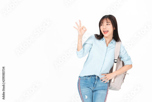 Happy Young Female Student Gesturing OK Sign with Backpack