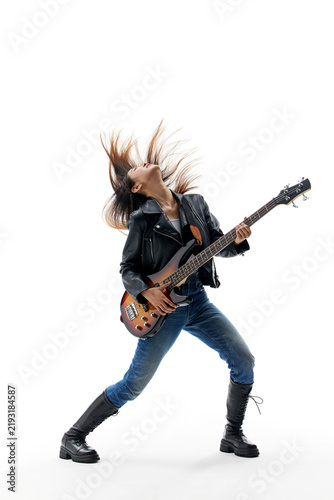 Картината върху платно Energetic female bassist performing rock music in studio