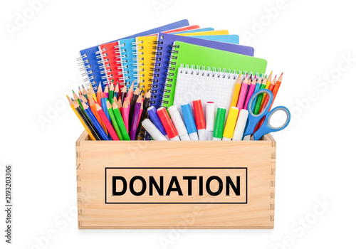 Wooden box full of school supplies for donation