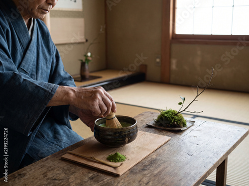 Traditional Japanese Matcha Tea Ceremony Hands Whisking Green Tea in Ceramic Bowl