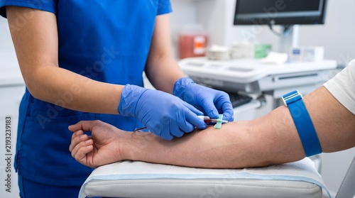 Medical professional drawing blood from patient for laboratory testing