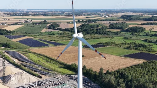 Sunrise over sustainable wind and solar energy farm