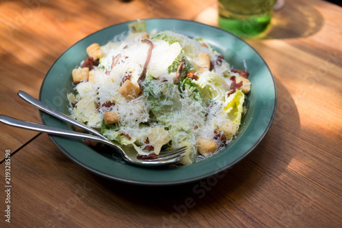 Фотография Close up of fresh caesar salad with croutons and parmasan cheese