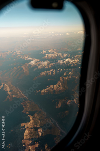 Aerial view of mountains from airplane window, atmospheric travel background