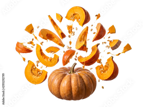 A dynamic image captures an orange pumpkin with its seeds and slices exploding outwards, symbolizing freshness, energy, and culinary possibilities.