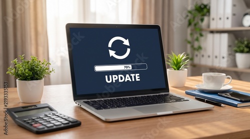 Laptop computer showing software update progress on screen in an office