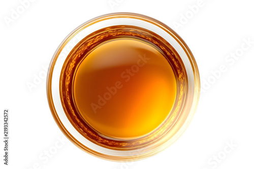 Top view of amber liquid in a clear glass, refreshing drink for parties or bars.