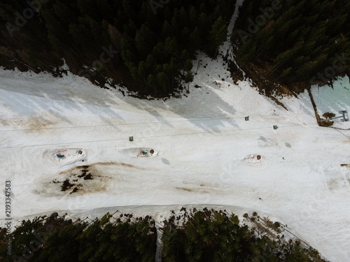 Bild auf Leinwand Snow-covered slope in Romania showing ski tracks and equipment set up, highlight