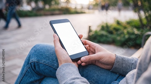 Smartphone mockup in hands. Person holding mobile phone outdoors. Photo.