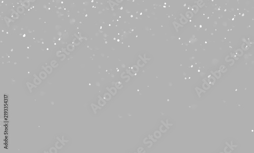 Fine falling snow with scattered snowflakes on a dark background. Natural winter weather texture for Christmas and New Year artwork.