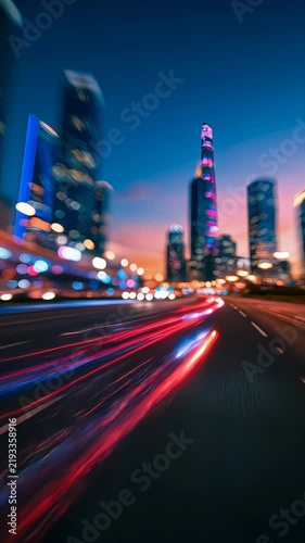 Futuristic urban skyline with vivid red and blue traffic light trails at night, symbolizing smart transportation, speed, digital technology and modern city life