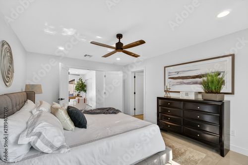 Spacious modern bedroom with king bed and dresser
