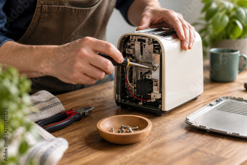 Repairing A Small Appliance On A Wooden Bench, close detail