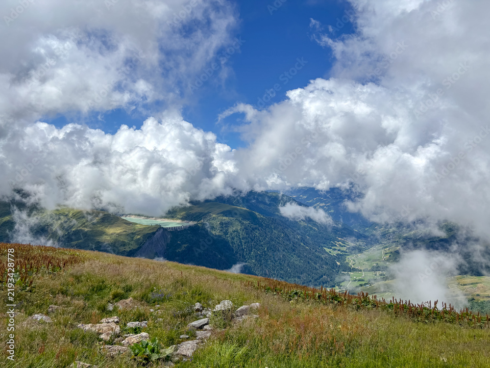 Obraz premium Cloudy alpine valley view from mountain meadow in Les Contamines-Montjoie, France
