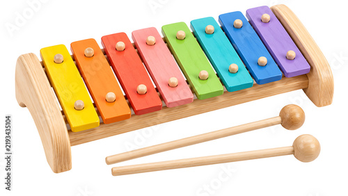 Wooden toy xylophone with rainbow colored bars and two mallets, music learning instrument isolated on transparent background for children education and play concepts.