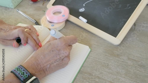 Elderly woman writing a new year 2027 to do list
