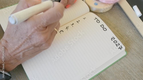 Woman writing a future to do list for 2027