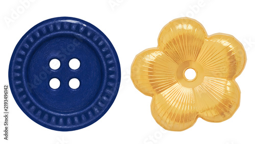Blue round four-hole sewing button and yellow flower-shaped decorative button isolated on white