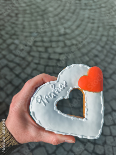 Photography Hand holding prague gingerbread heart cookie celebrating fall