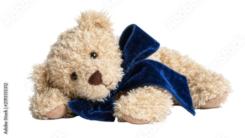 фотографія Fluffy beige teddy bear with dark blue velvet bow, isolated on transparent backg
