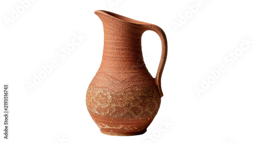 Bild auf Leinwand Rustic terracotta jug with textured surface and decorative patterns, isolated on