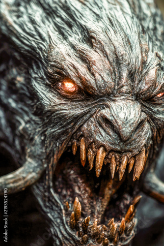 Close-up shot of a demonic-looking creature with horns and sharp teeth, suitable for horror or fantasy themes. vertical frame