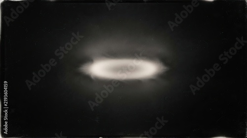 Abstract glowing oval light ring on a dark textured background