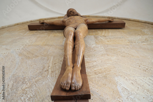 Obraz na plátne carved wooden crucifix of Jesus Christ holy trinity cathedral of Tbilisi Georgia Focus on foot fingers  holy cross hanging in the church