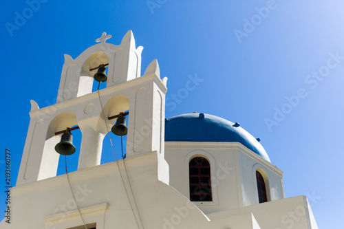 Canvastavla White Greek church and bell tower beneath a blue sky