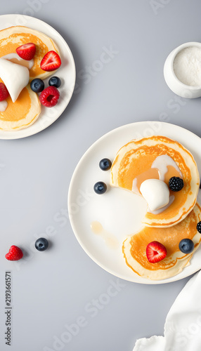 Tasty pancakes with berries served on grey table, space for text. Banner design, flat design. White tone