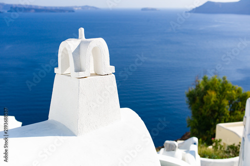 Fotografie White church bell tower overlooking the blue sea