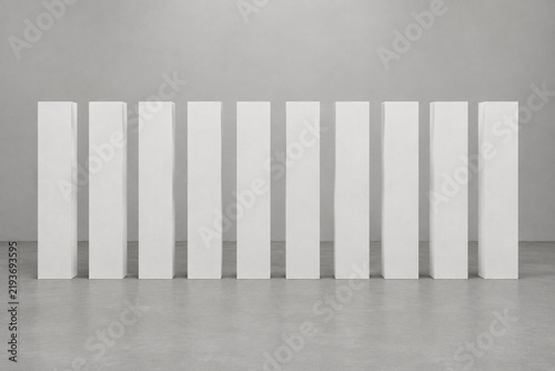 Ten identical smooth white plaster columns in perfect alignment.