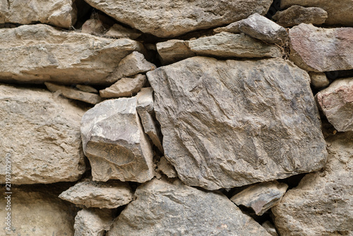 Принти на полотні Close-up of a rustic stone wall displaying an assortment of natural stones with