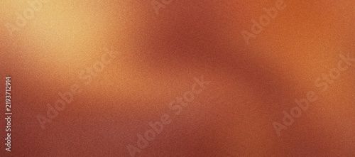 Warm orange light leak background with vintage film grain texture. Abstract copper glow overlay for retro photography. Soft amber bokeh effect on dark brown gradient for cinematic backdrop.