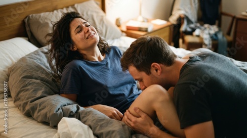 Obraz na płótnie Couple in Bed Embracing with Intimacy